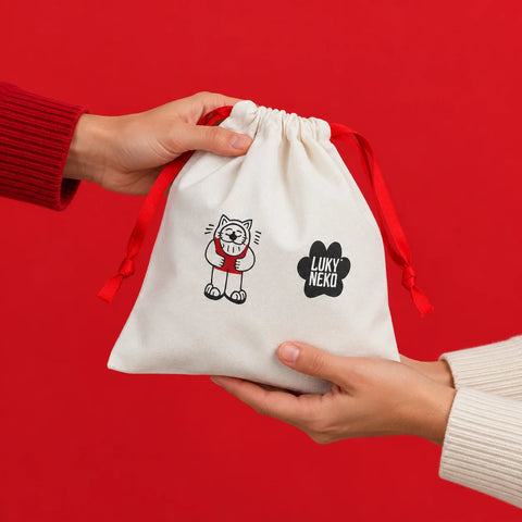 Lucky Bag 2027 cotton drawstring bag with Luky the cat, handed from one person to another