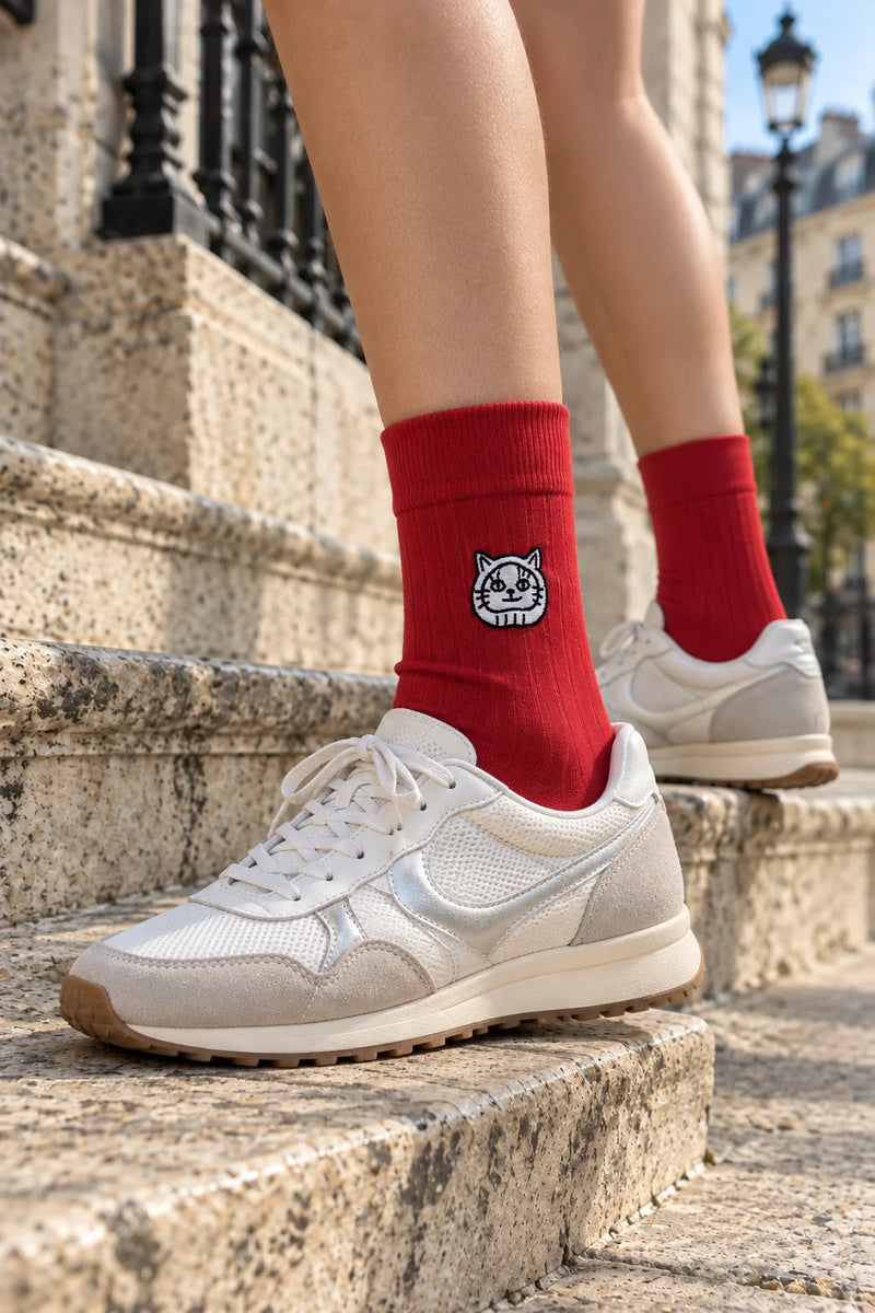 Red LukyNeko lucky socks worn on the steps of Paris